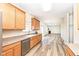 Open kitchen with hardwood floors offering a view of the living area at 12912 Broncos Dr, Fishers, IN 46037