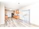 Modern kitchen with stainless steel appliances, wood cabinets, and a sliding glass door to the backyard at 12912 Broncos Dr, Fishers, IN 46037