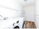 Efficient laundry room with washer, dryer, and ample shelving at 12912 Broncos Dr, Fishers, IN 46037
