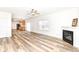 Hardwood floors in an open floor plan connecting to the kitchen with stainless steel appliances at 12912 Broncos Dr, Fishers, IN 46037