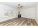 Bright living room featuring a cozy fireplace, ceiling fan, and hardwood floors at 12912 Broncos Dr, Fishers, IN 46037