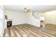 Open-concept living space featuring a fireplace, hardwood floors, staircase, and natural light at 12912 Broncos Dr, Fishers, IN 46037