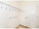 Bright mud room with wood-look flooring and coat hooks at 12912 Broncos Dr, Fishers, IN 46037