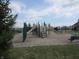 Community playground with multiple slides, climbing structures, and wood chip ground cover at 12912 Broncos Dr, Fishers, IN 46037
