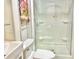 This bright bathroom features white beadboard walls, compact sink and fixtures, and glass enclosed shower at 335 N Grant Ave, Indianapolis, IN 46201