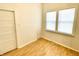This bright bedroom features wood floors, neutral walls, and natural light from a window at 335 N Grant Ave, Indianapolis, IN 46201