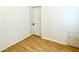 This bright bedroom features wood floors, neutral walls, and natural light from a window at 335 N Grant Ave, Indianapolis, IN 46201