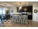 Bright kitchen with modern appliances, an island with seating, and open access to the dining area at 3503 W 100 N, Bargersville, IN 46106