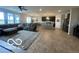 Open-concept living room featuring a large sectional sofa, rug, and dark stained cabinets in the kitchen at 3503 W 100 N, Bargersville, IN 46106