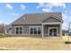 Backyard view of home featuring patio area, large windows, and gray siding at 5034 Bergamot Dr, Brownsburg, IN 46112