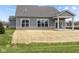 Backyard view of home featuring patio area, large windows, and gray siding at 5034 Bergamot Dr, Brownsburg, IN 46112
