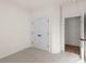 Simple bedroom with carpet, double doors to closet, and access to hallway at 5034 Bergamot Dr, Brownsburg, IN 46112