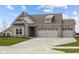 Charming single-story home with a well-manicured lawn, brick facade, and two-car garage at 5034 Bergamot Dr, Brownsburg, IN 46112