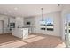 Modern kitchen with white cabinets, island, and stainless steel appliances at 5034 Bergamot Dr, Brownsburg, IN 46112