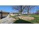 View of backyard and the house, with an attached garage, shed, and beautiful lawn at 5861 S 100 W, Fountaintown, IN 46130