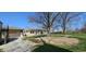 View of backyard and the house, with an attached garage, shed, and beautiful lawn at 5861 S 100 W, Fountaintown, IN 46130