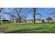 Spacious backyard with grass and mature trees along with a shed and view of the house at 5861 S 100 W, Fountaintown, IN 46130