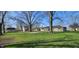 Spacious backyard with grass and mature trees along with a shed and view of the house at 5861 S 100 W, Fountaintown, IN 46130