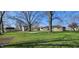Spacious backyard with grass and mature trees along with a shed and view of the house at 5861 S 100 W, Fountaintown, IN 46130