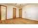 A bedroom with hardwood floors featuring a door leading to a bathroom at 5861 S 100 W, Fountaintown, IN 46130