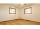 A bright bedroom featuring hardwood floors and two windows at 5861 S 100 W, Fountaintown, IN 46130