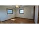 The bedroom boasts hardwood floors, two windows for natural light and a ceiling fan at 5861 S 100 W, Fountaintown, IN 46130