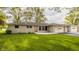 Charming single-story home featuring a stone facade, attached two-car garage, and lush green lawn at 5861 S 100 W, Fountaintown, IN 46130