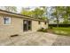 Exterior view of the home featuring a stone wall and patio at 5861 S 100 W, Fountaintown, IN 46130