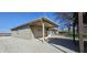 A detached garage with a covered area offers parking and extra storage, set on a gravel lot at 5861 S 100 W, Fountaintown, IN 46130