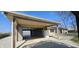 This detached garage with an adjoining carport provides parking and storage with a refrigerator at 5861 S 100 W, Fountaintown, IN 46130