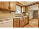 Eat-in kitchen boasting wood cabinets, laminate countertops and a double sink at 5861 S 100 W, Fountaintown, IN 46130