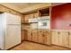 Eat-in kitchen showcasing wood cabinets, laminate countertops, and appliances at 5861 S 100 W, Fountaintown, IN 46130