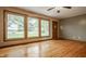 Hardwood floors, a ceiling fan and a large window illuminate the home at 5861 S 100 W, Fountaintown, IN 46130