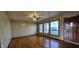 Hardwood floors in the living room reflect natural light from the large front windows and entry door at 5861 S 100 W, Fountaintown, IN 46130