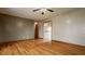 The open living room offers a ceiling fan and gorgeous wood floors at 5861 S 100 W, Fountaintown, IN 46130