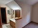 This bathroom features a single sink with wood cabinets, light fixtures, and a decorative half wall at 6640 Greenridge Dr, Indianapolis, IN 46278