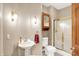 Bathroom features tile floor, pedestal sink, cabinet, and glass enclosed shower at 6640 Greenridge Dr, Indianapolis, IN 46278