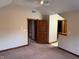 This carpeted bedroom offers multiple wooden doors leading to other rooms, baseboard trim, and neutral paint at 6640 Greenridge Dr, Indianapolis, IN 46278