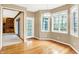 Dining area with hardwood floors, large windows, and chandelier lighting at 6640 Greenridge Dr, Indianapolis, IN 46278