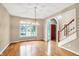 Bright dining room with hardwood floors, elegant chandelier, large window, and doorway to foyer at 6640 Greenridge Dr, Indianapolis, IN 46278