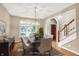 Formal dining room showcasing chandelier, hardwood floors, and large window letting in natural light at 6640 Greenridge Dr, Indianapolis, IN 46278