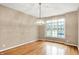 Spacious dining room featuring hardwood floors, large bay window, and neutral walls at 6640 Greenridge Dr, Indianapolis, IN 46278