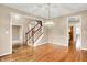 Open-concept foyer with hardwood floors, staircase and views into other living spaces at 6640 Greenridge Dr, Indianapolis, IN 46278