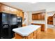 Kitchen with stainless steel refrigerator, island and hardwood flooring at 6640 Greenridge Dr, Indianapolis, IN 46278