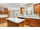 Kitchen featuring wood cabinets, hardwood floors, an island, and stainless steel sink at 6640 Greenridge Dr, Indianapolis, IN 46278