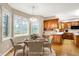 Eat-in kitchen with wood cabinetry, stainless steel microwave, hardwood floors, and bright light at 6640 Greenridge Dr, Indianapolis, IN 46278