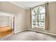 Bright living room featuring a large arched window with curtains and neutral carpet at 6640 Greenridge Dr, Indianapolis, IN 46278