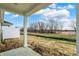 View from a back porch, revealing a large, flat backyard with trees in the distance at 18415 Depoe Ln, Westfield, IN 46074