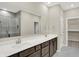 Modern bathroom featuring a double sink vanity, large mirror, and glass-enclosed shower at 18415 Depoe Ln, Westfield, IN 46074