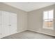 This bedroom features neutral paint, carpet, a double-door closet, and natural light from a window at 18415 Depoe Ln, Westfield, IN 46074